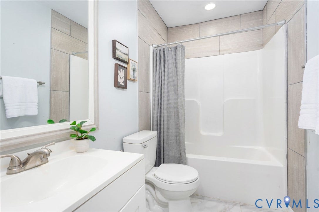 White vanity with an integrated sink and brushed nickel faucet