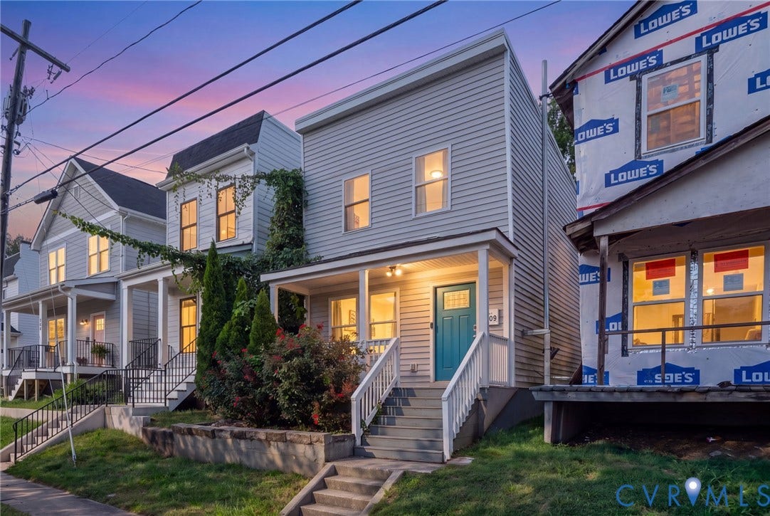 Light gray siding exterior with a distinctive teal front door