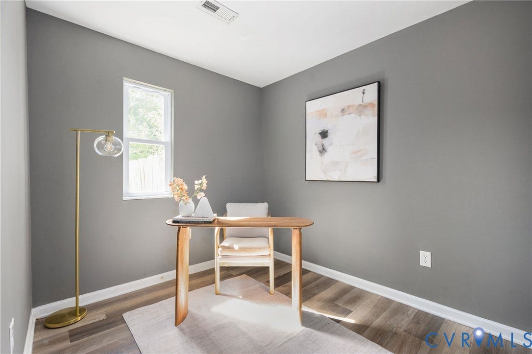 Recessed lighting fixture, light gray wall finish, single window, wood-finish flooring, white trim details