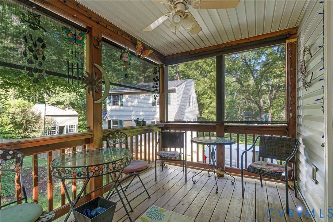 307 Poplar Dr, Louisa, VA 23093 Screened porch featuring a wood-finish floor, wood railings, and a ceiling fan