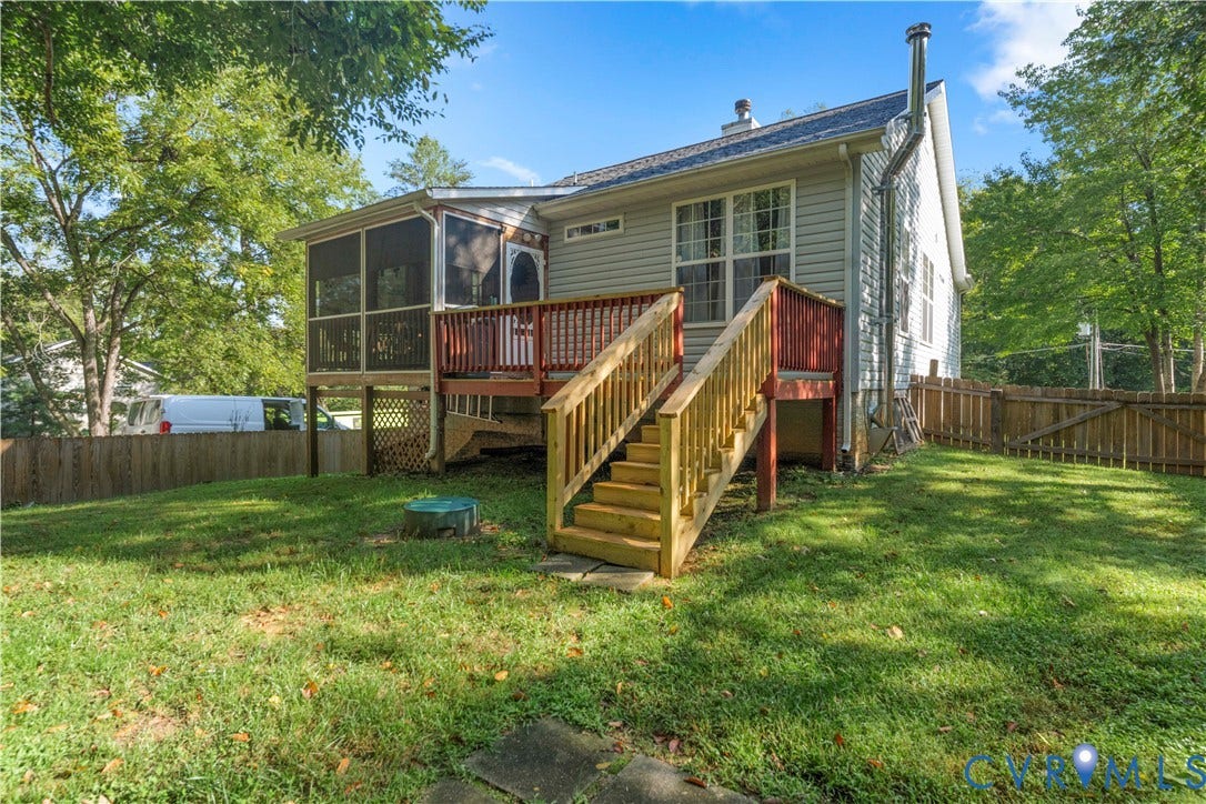 307 Poplar Dr, Louisa, VA 23093 Expansive backyard featuring a screened porch, wood deck, and wooden privacy fencing