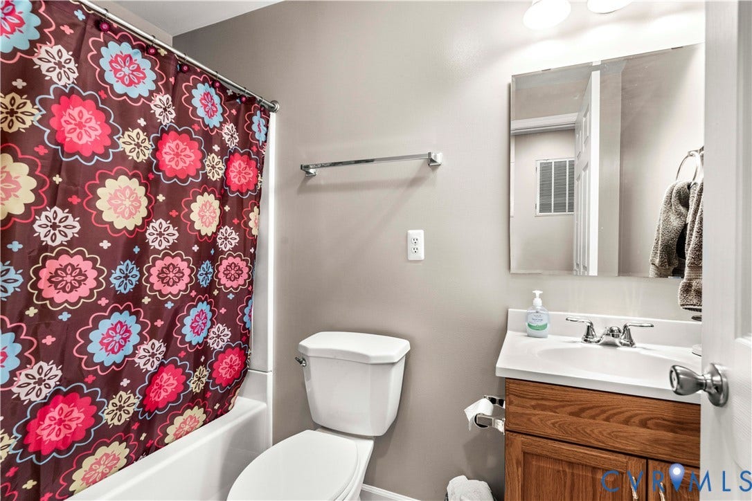 307 Poplar Dr, Louisa, VA 23093 Vanity with wood-finish cabinetry, white countertop, and integrated sink