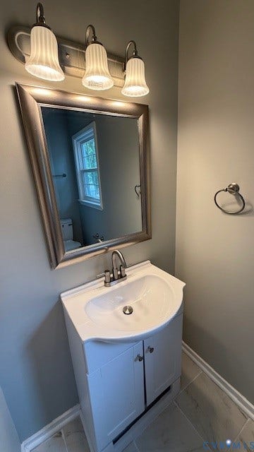 1424 Decatur Street, Rhodes Plan, Richmond, VA 23224 White vanity with integrated sink, brushed nickel faucet, framed mirror, and three-light vanity fixture