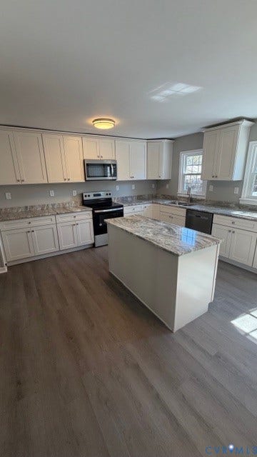 1424 Decatur Street, Rhodes Plan, Richmond, VA 23224 Kitchen featuring white cabinetry, light-toned countertops, a center island, stainless steel appliances, and wood-finish flooring