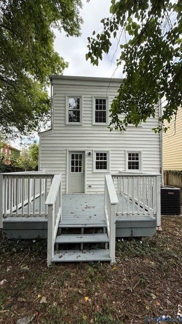 1424 Decatur Street, Rhodes Plan, Richmond, VA 23224 Two-story exterior with white siding, showcasing a wooden deck with railings and steps leading to a ground-level area
