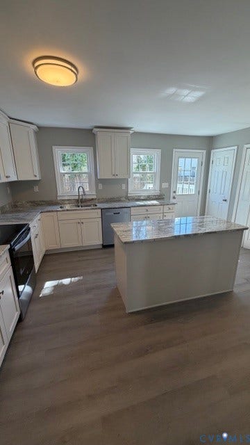 1424 Decatur Street, Rhodes Plan, Richmond, VA 23224 Kitchen featuring white cabinetry, light-toned countertops, a center island, stainless steel appliances, and wood-finish flooring