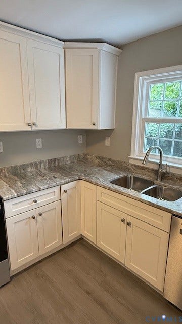1424 Decatur Street, Rhodes Plan, Richmond, VA 23224 White shaker-style cabinetry, patterned countertops, double basin stainless steel sink with a gooseneck faucet, and wood-finish flooring