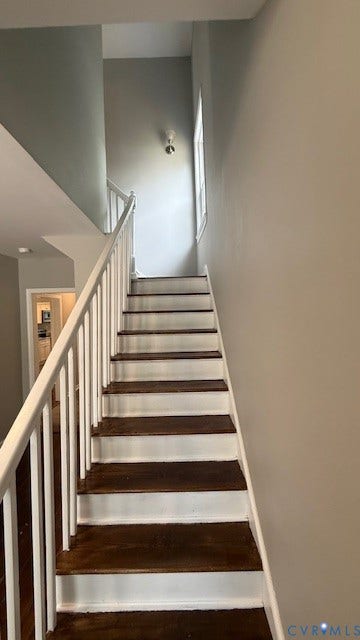 1424 Decatur Street, Rhodes Plan, Richmond, VA 23224 Wood-finish treads with painted risers, white painted balusters and handrail, and a high ceiling with a window