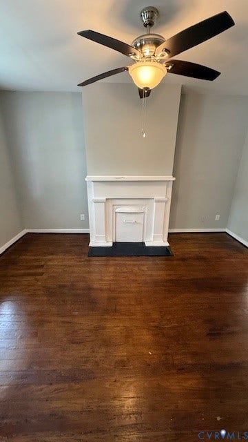 1424 Decatur Street, Rhodes Plan, Richmond, VA 23224 Dark wood-finish flooring with white baseboards, a white fireplace mantel, and a ceiling fan with integrated lighting