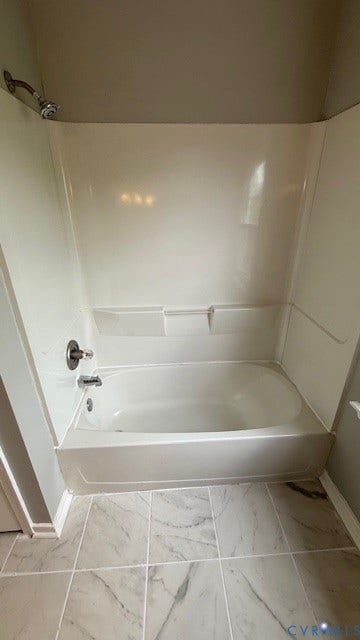1424 Decatur Street, Rhodes Plan, Richmond, VA 23224 Bathtub and shower combination with chrome fixtures and integrated shelving, complemented by tile flooring