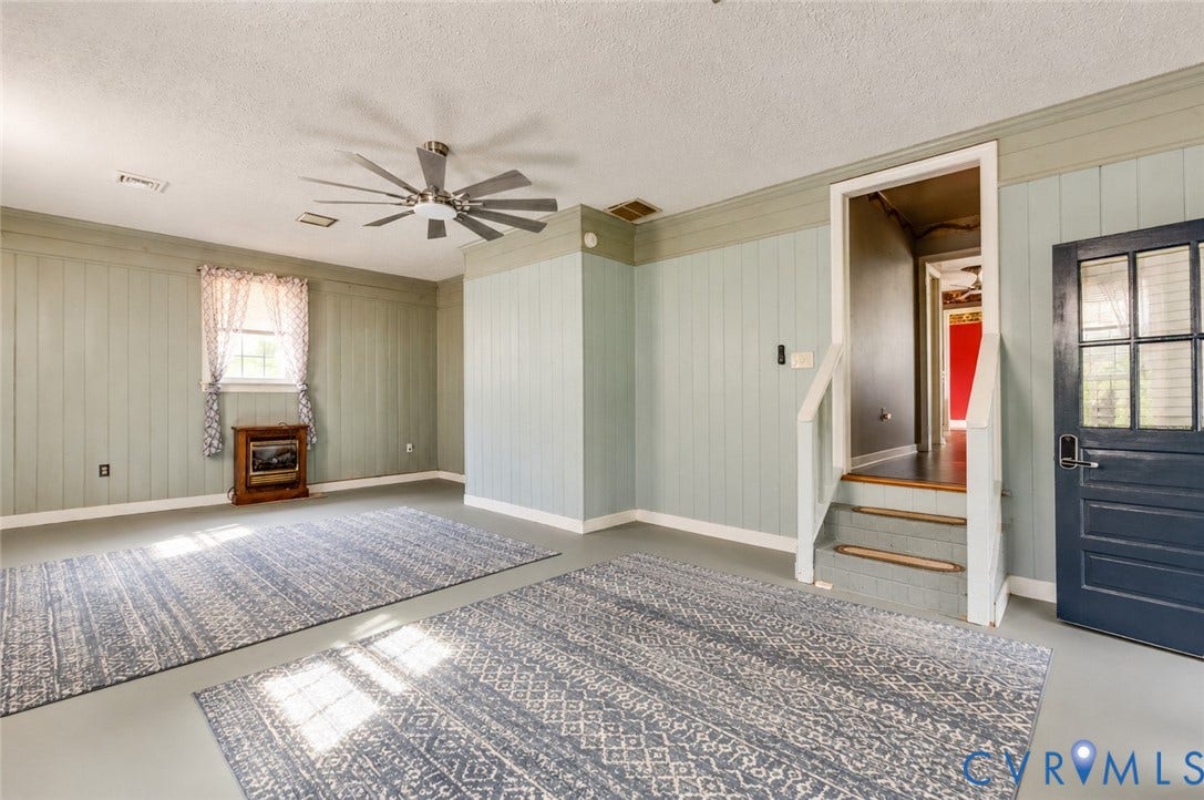 Recessed lighting, ceiling fan, wood paneling, interior window, and built-in entry steps