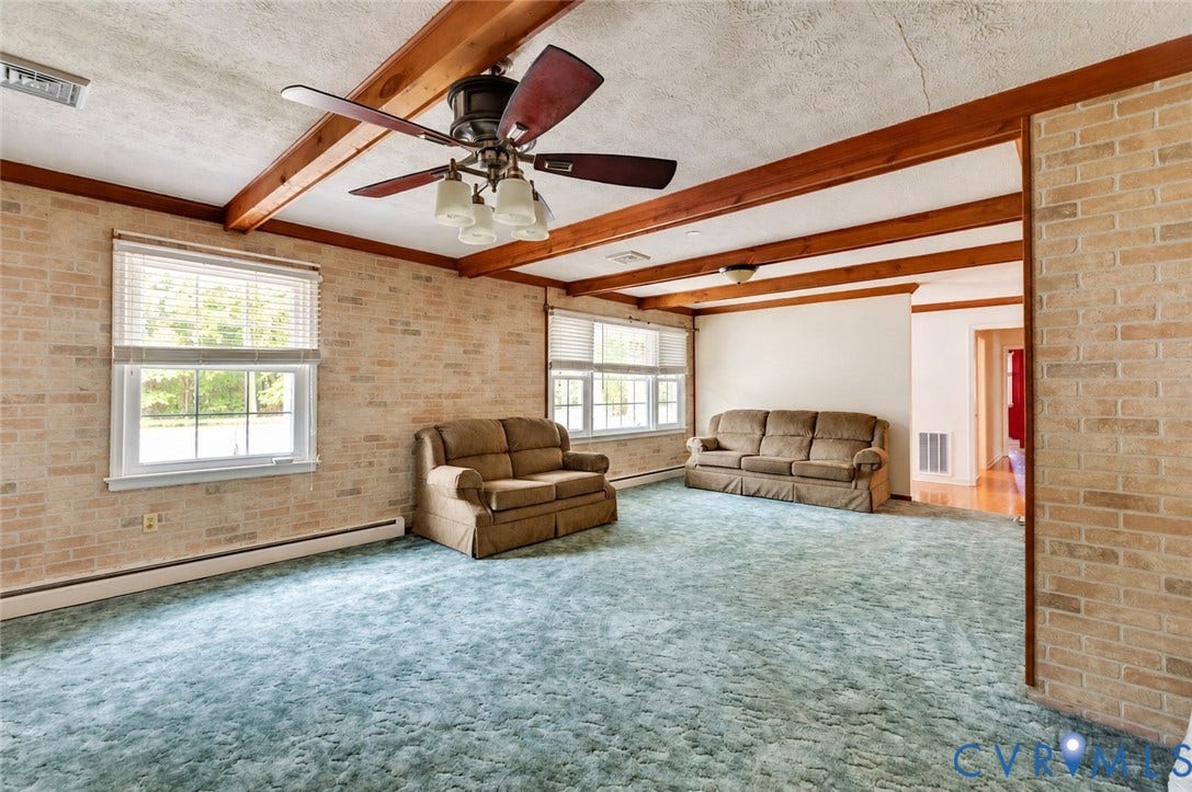 Exposed beam ceiling with a central ceiling fan