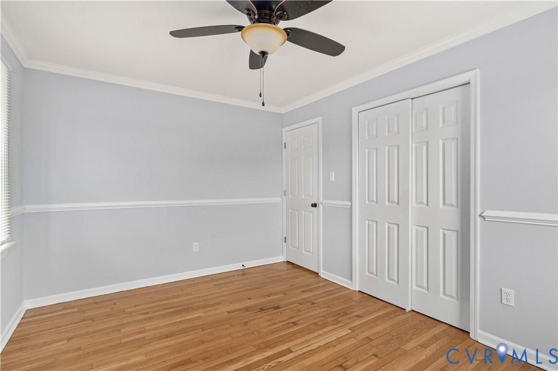 5221 Ecoff Avenue, Chester, VA 23831 Wood flooring, ceiling fan with integrated lighting, crown molding, chair rail molding, and panel doors