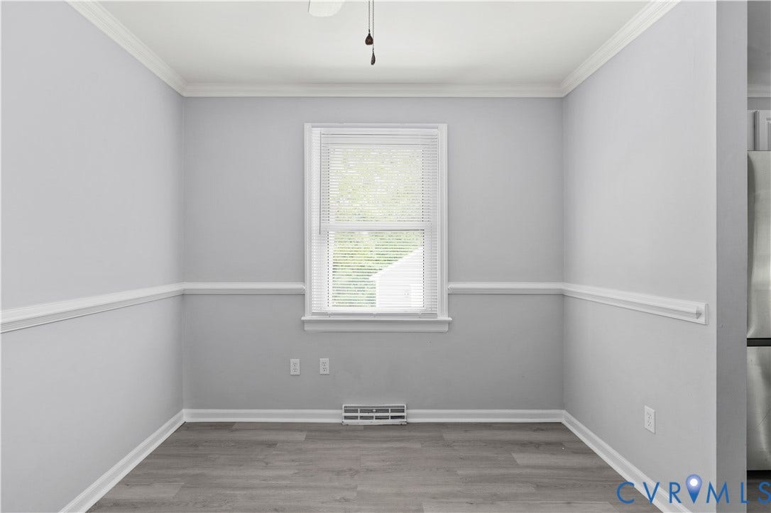 5221 Ecoff Avenue, Chester, VA 23831 Light gray walls with chair rail molding and crown molding, wood-finish flooring, and a ceiling fan