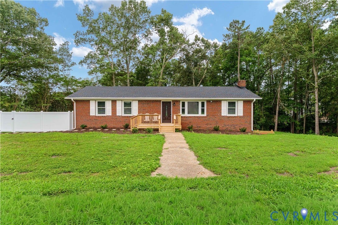 5221 Ecoff Avenue, Chester, VA 23831 Brick exterior with white window shutters, a wooden front porch, and a dark shingle roof