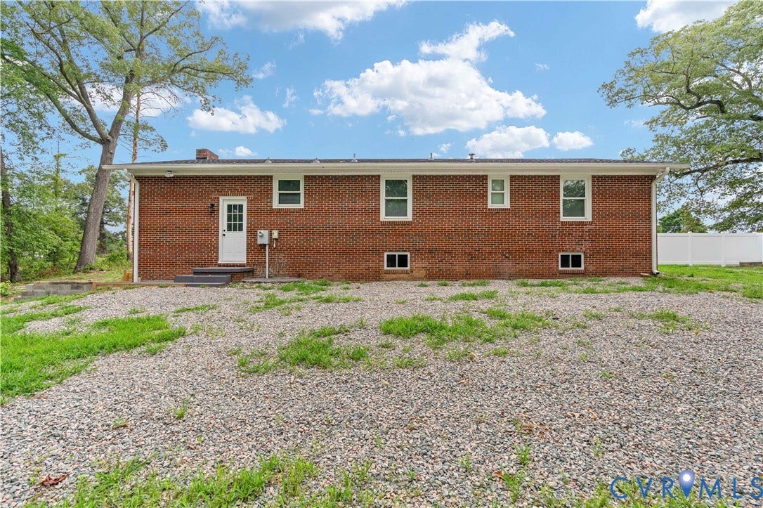 5221 Ecoff Avenue, Chester, VA 23831 Red brick exterior with white trim windows and a white paneled door