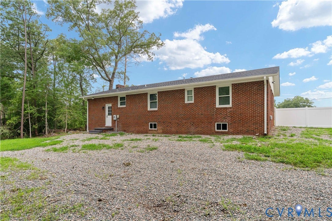 5221 Ecoff Avenue, Chester, VA 23831 Brick exterior with white window trim and a white rear entry door