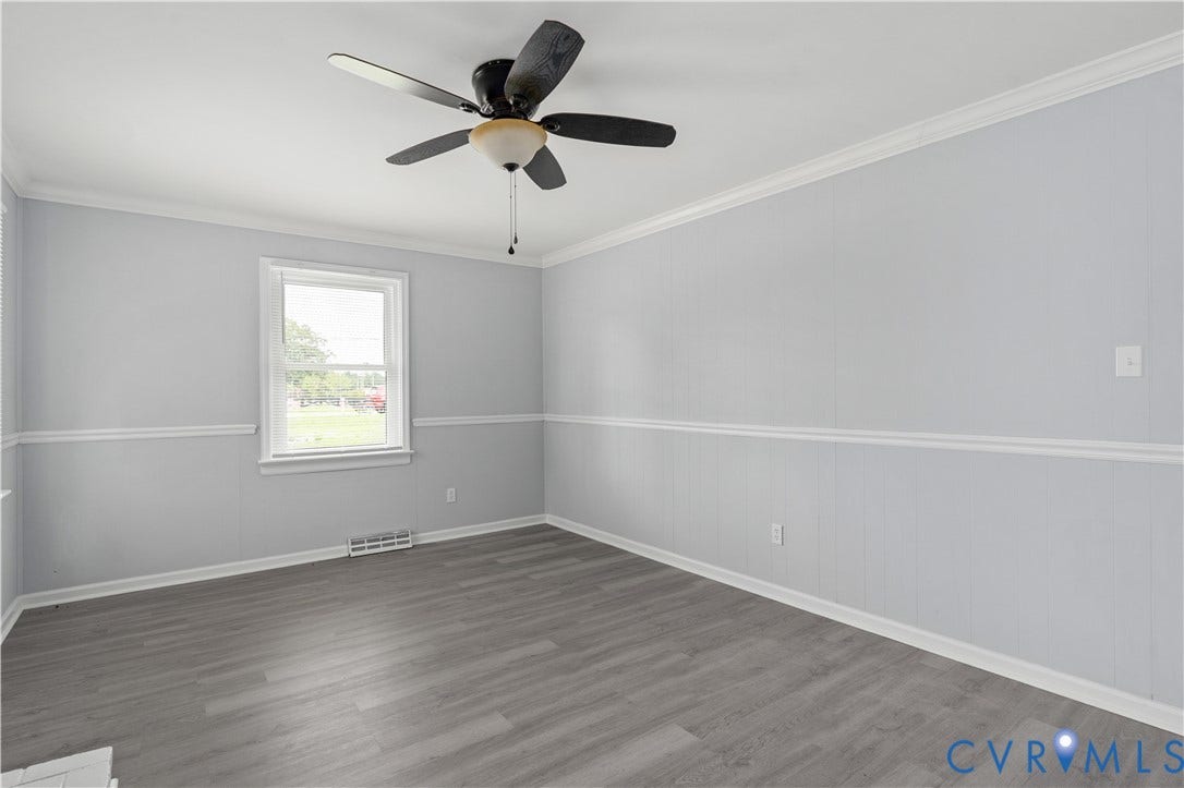 5221 Ecoff Avenue, Chester, VA 23831 Wood-finish flooring, ceiling fan with integrated lighting, window with white trim, and crown molding