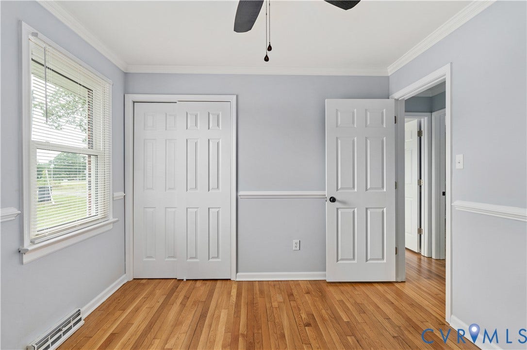 5221 Ecoff Avenue, Chester, VA 23831 Hardwood flooring, painted walls, white trim, paneled doors, and a ceiling fan