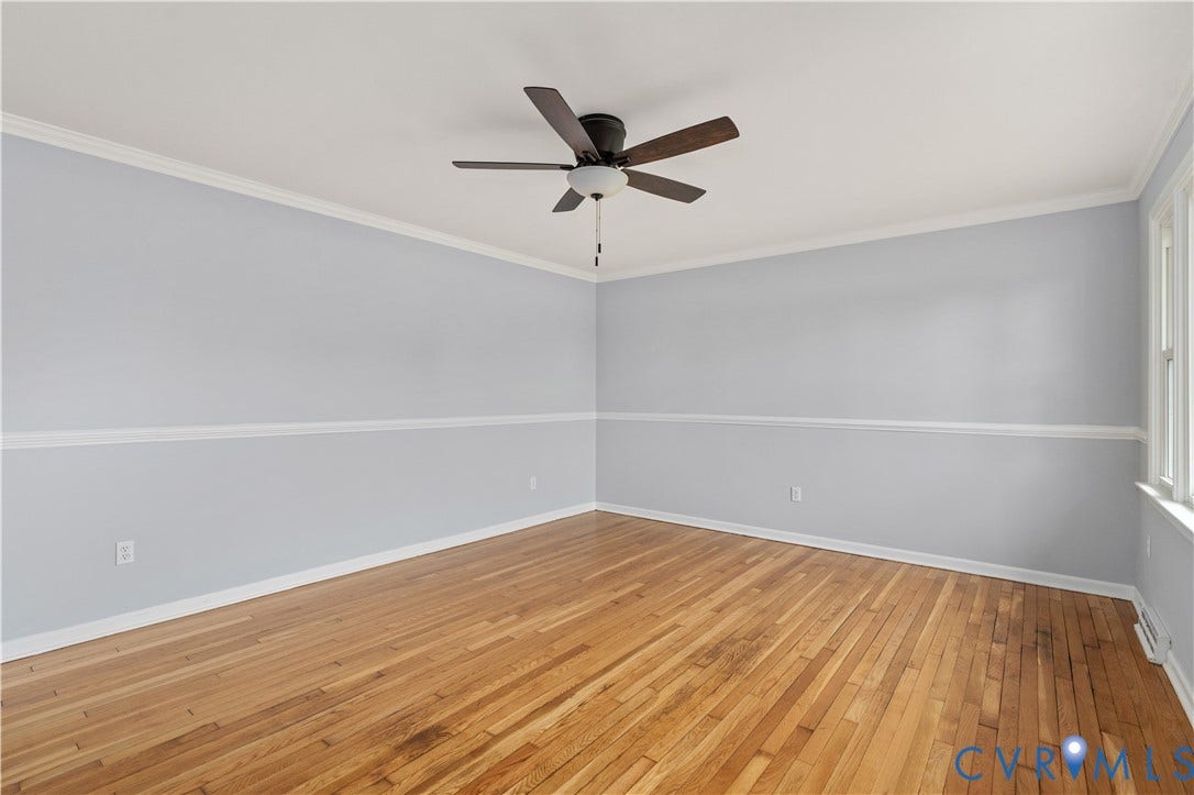 5221 Ecoff Avenue, Chester, VA 23831 Hardwood flooring, painted walls with chair rail and crown molding, ceiling fan with integrated lighting, and windows providing natural illumination