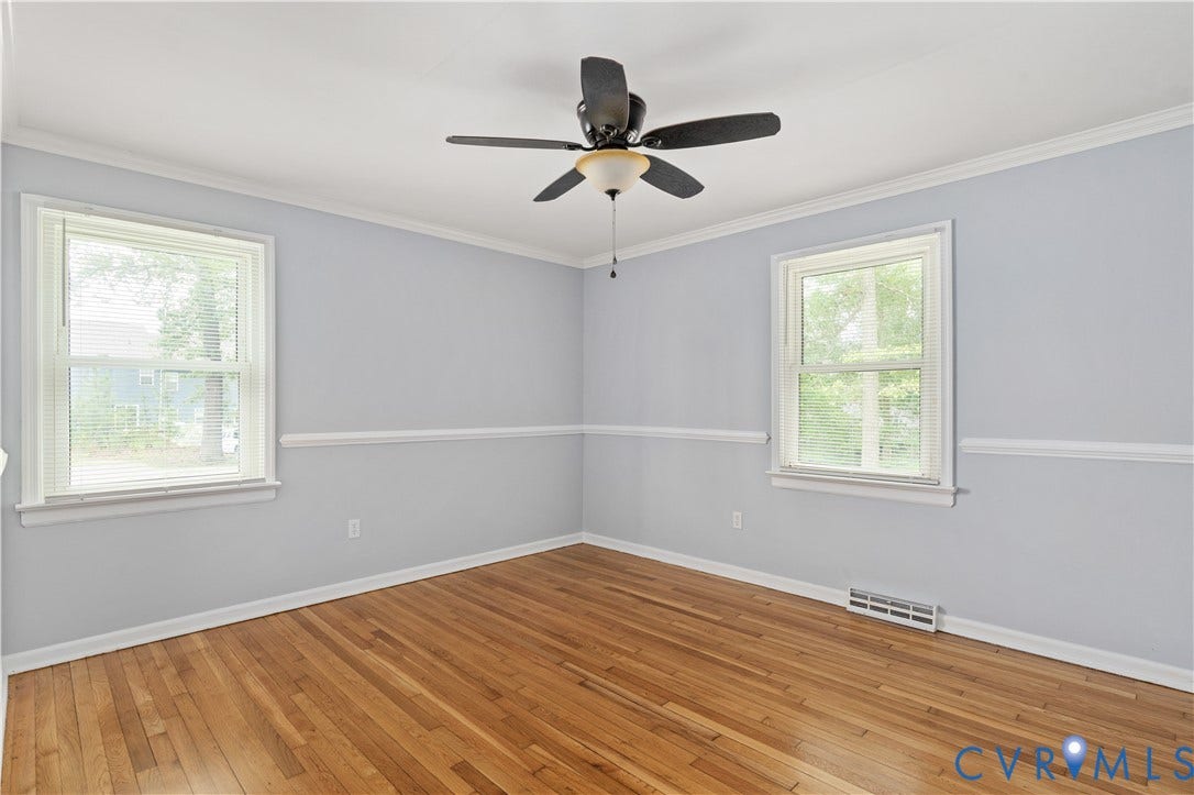 5221 Ecoff Avenue, Chester, VA 23831 Hardwood flooring, two windows, crown molding, chair rail molding, and a ceiling fan