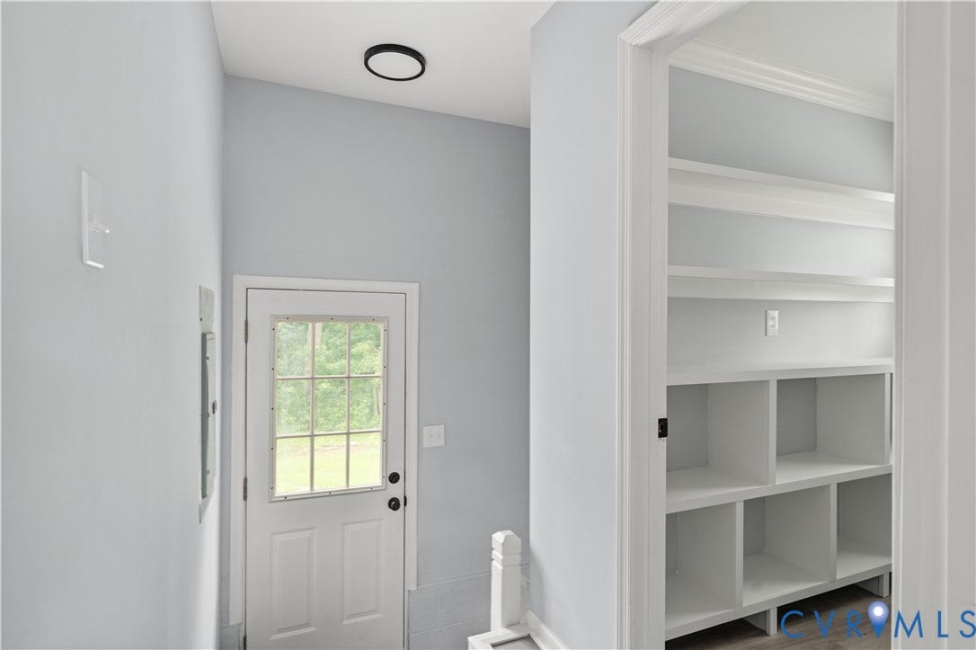 5221 Ecoff Avenue, Chester, VA 23831 Built-in shelving with crown molding, paneled door with window, and a flush-mount ceiling light fixture