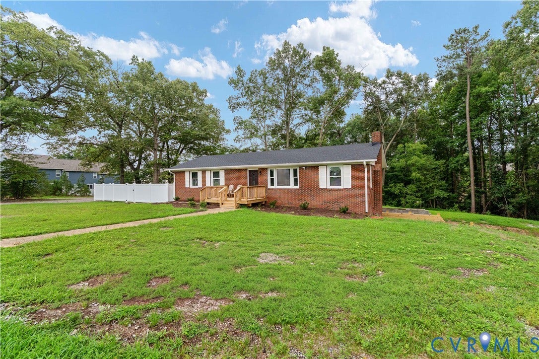 5221 Ecoff Avenue, Chester, VA 23831 Brick exterior with white shutters, a wood front porch, and a white picket fence