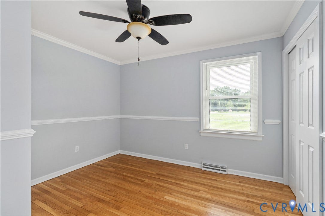 5221 Ecoff Avenue, Chester, VA 23831 Hardwood flooring, crown molding, chair rail detailing, ceiling fan with light fixture, and window with blinds