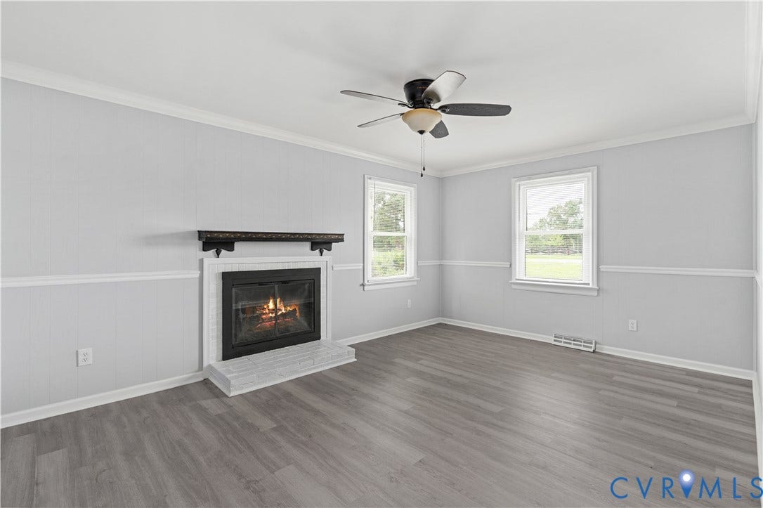 5221 Ecoff Avenue, Chester, VA 23831 Wood-finish flooring throughout, featuring a fireplace with a white-painted brick hearth