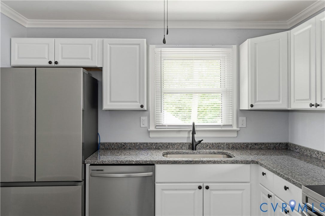 5221 Ecoff Avenue, Chester, VA 23831 White cabinetry, stainless steel appliances, dark countertop, single basin sink, and crown molding