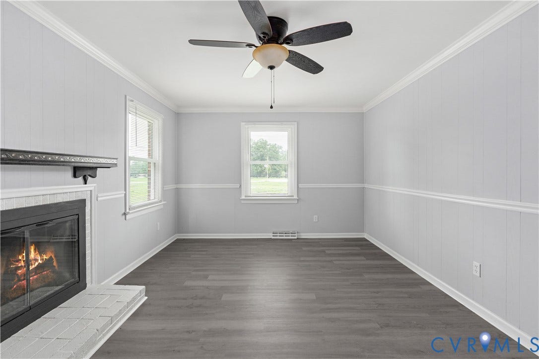 5221 Ecoff Avenue, Chester, VA 23831 Fireplace with a tile hearth and mantel, wood-finish flooring, two windows, ceiling fan, and crown molding