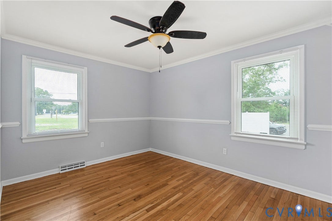 5221 Ecoff Avenue, Chester, VA 23831 Hardwood flooring, crown molding, chair rail molding, ceiling fan, and window with blinds