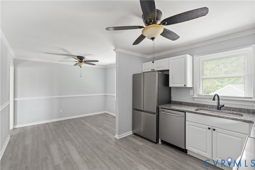 5221 Ecoff Avenue, Chester, VA 23831 Kitchen area featuring stainless steel appliances, white cabinetry with dark hardware, a single basin sink with a dark faucet, and light-toned countertop