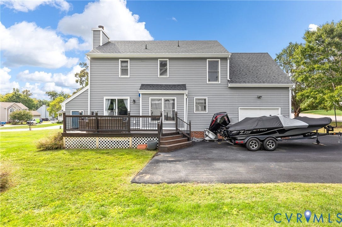 7625 Southford Lane, Chesterfield, VA 23832 Siding exterior with multiple windows, an attached garage, and a rear deck featuring wood railings
