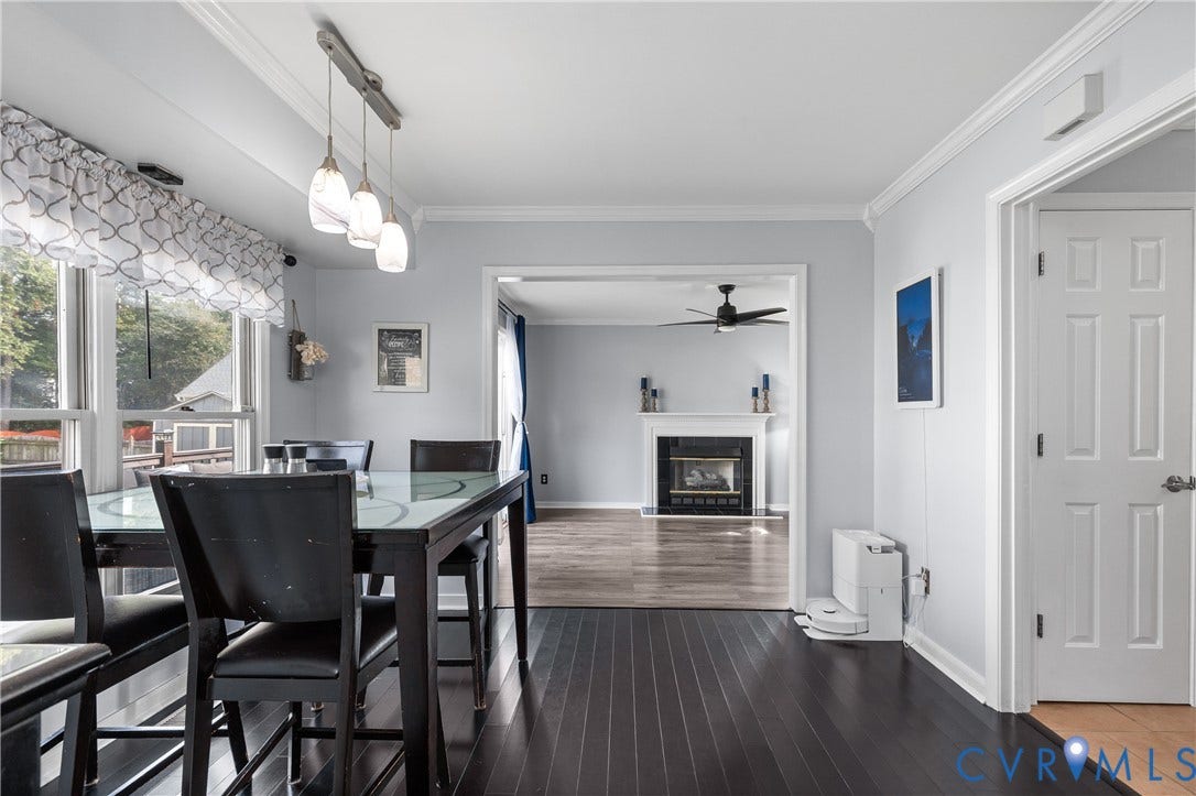 7625 Southford Lane, Chesterfield, VA 23832 Dark wood-finish flooring, white crown molding, pendant lighting fixture, and a white six-panel door