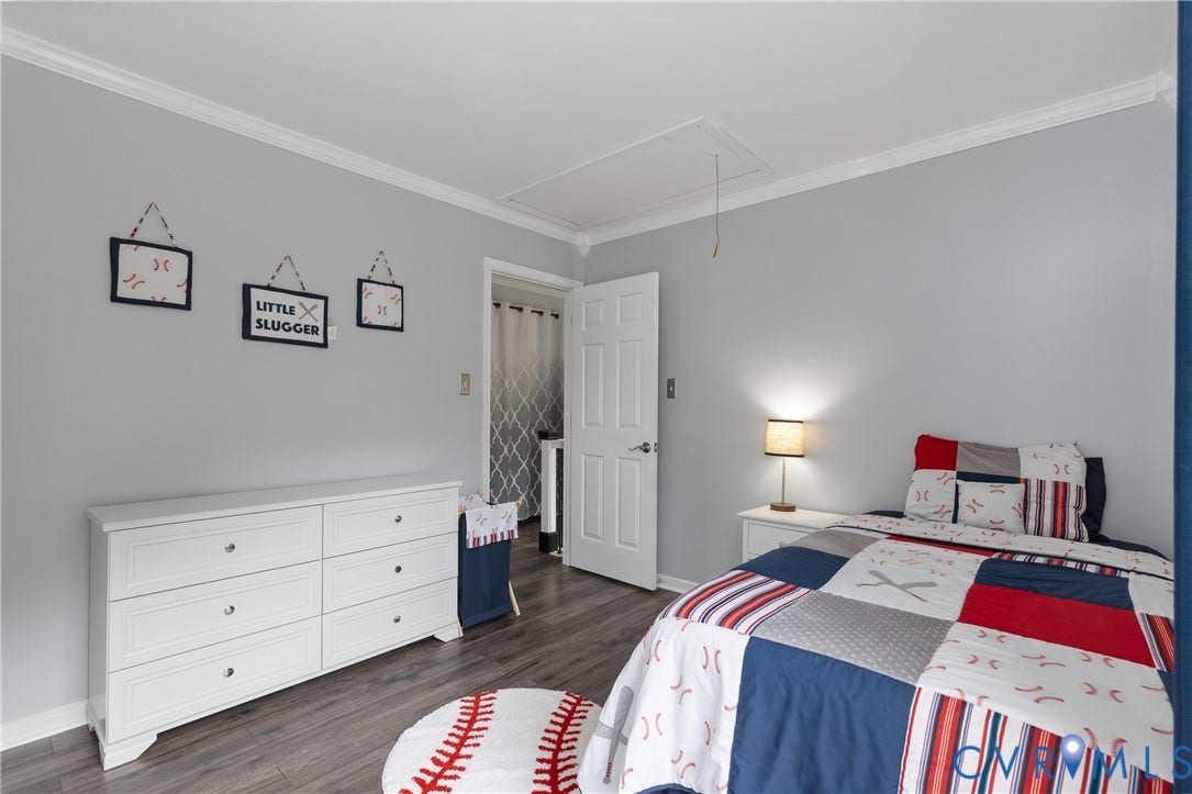 7625 Southford Lane, Chesterfield, VA 23832 Bright secondary bedroom featuring soft gray walls, wood-finish flooring, and ample natural light