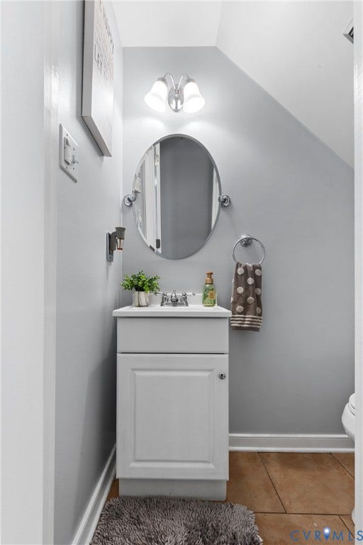 7625 Southford Lane, Chesterfield, VA 23832 Vanity with white cabinet, chrome faucet, oval mirror, and wall-mounted light fixture