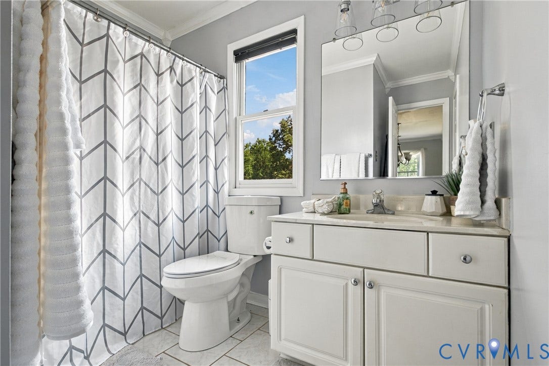 7625 Southford Lane, Chesterfield, VA 23832 White vanity with a light-toned countertop, framed mirror, and chrome fixtures