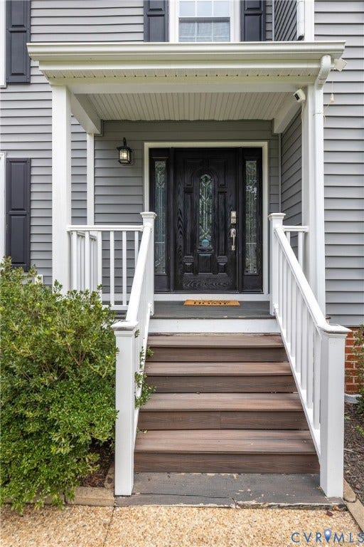 7625 Southford Lane, Chesterfield, VA 23832 Siding exterior with decorative shutters, covered entry with white railing, wood-finish stairs, and an ornate dark wood door with glass inserts