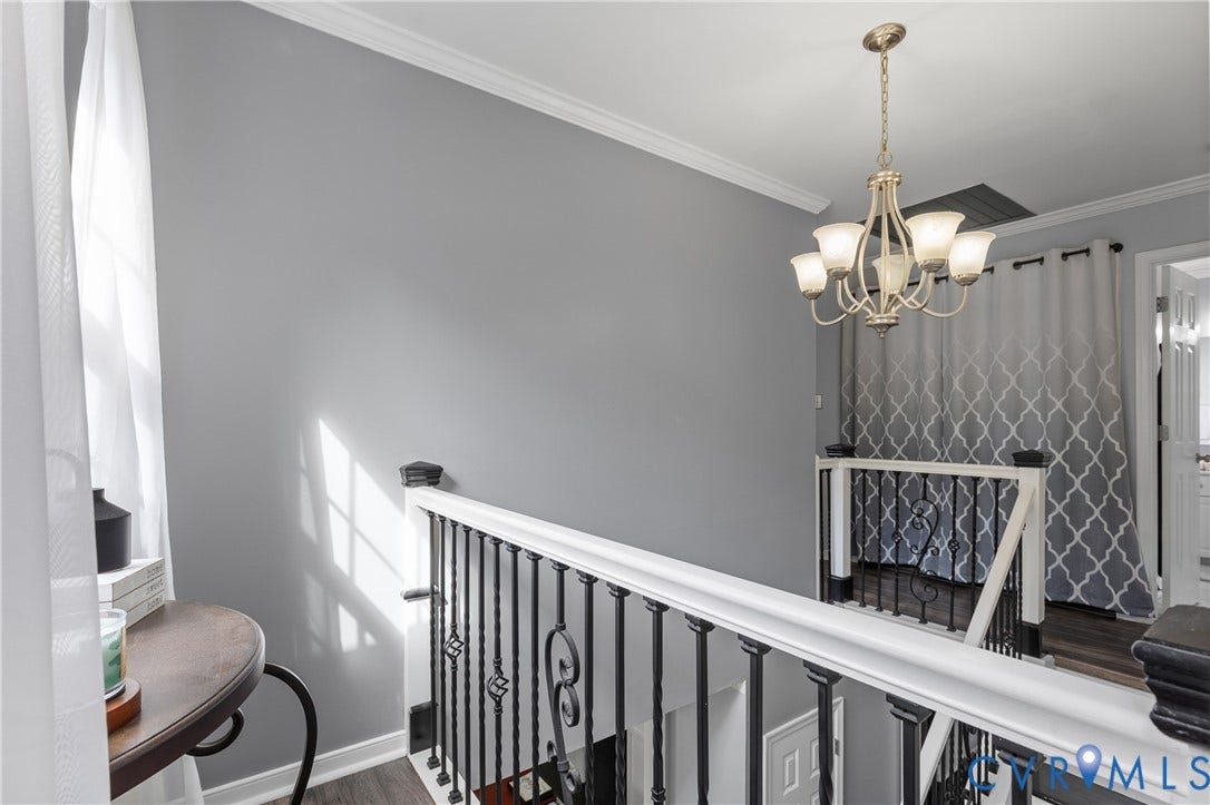 7625 Southford Lane, Chesterfield, VA 23832 Elegant upper-level landing featuring soft gray walls, white railings with black metal balusters, and a polished white wood-finish railing
