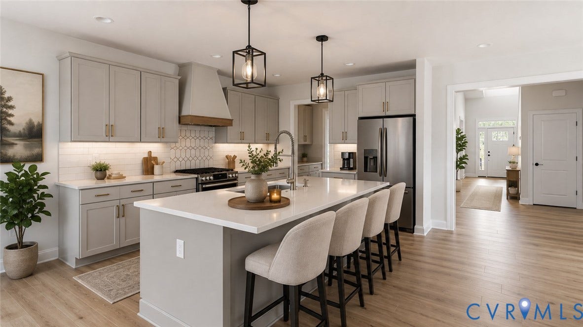 Kitchen featuring light-toned cabinetry, stainless steel appliances, a center island with counter seating, and wood-finish flooring