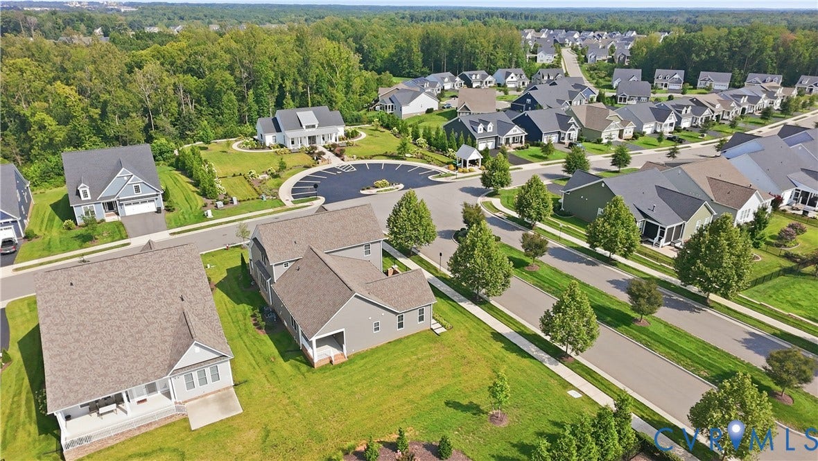 Residential community with tree-lined streets, manicured lawns, and varied architectural styles