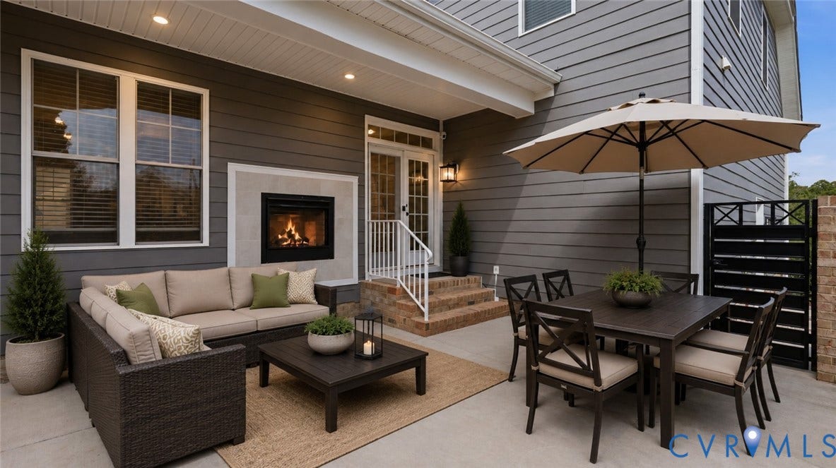 Spacious outdoor patio with an integrated fireplace and recessed lighting