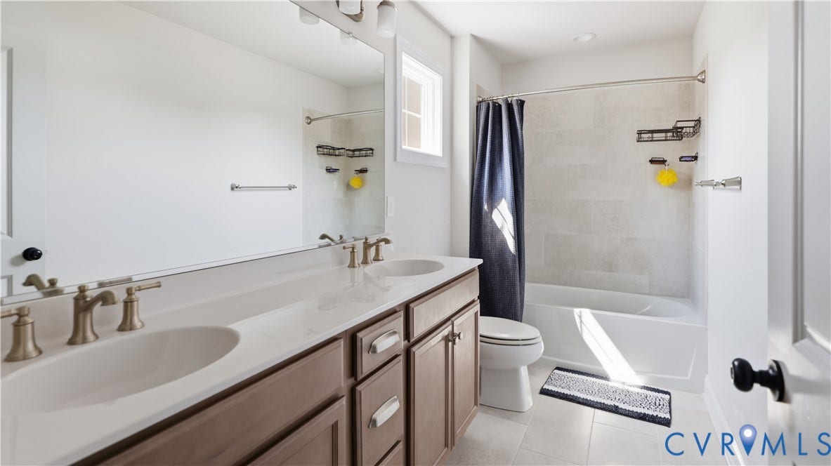 Double vanity with brushed nickel fixtures, under-mount sinks, and a large mirror