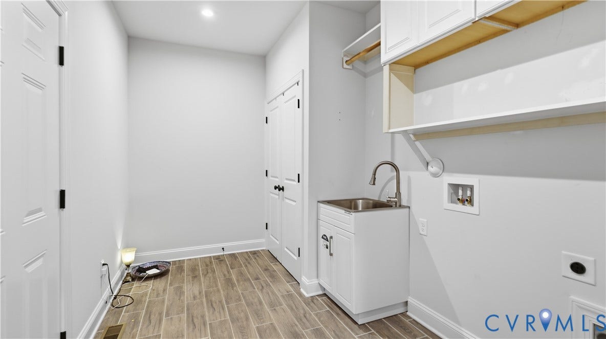 White cabinetry with a stainless steel sink and a gooseneck faucet