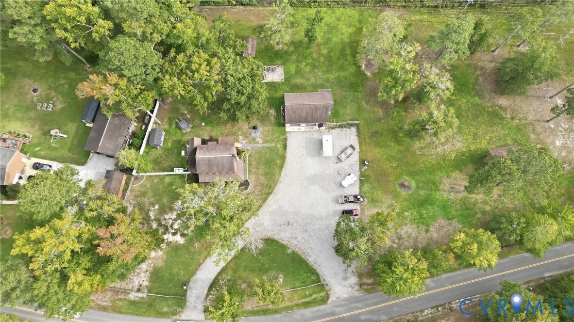 6723 Bull Hill Road, Prince George, VA 23875 Multiple structures on a spacious, tree-lined property with a gravel driveway