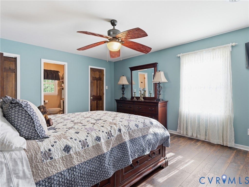 6723 Bull Hill Road, Prince George, VA 23875 Room interior featuring wood-finish flooring, a ceiling fan with integrated lighting, and natural wood-finish interior doors