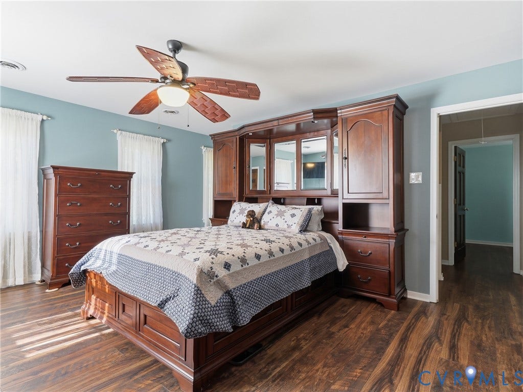 6723 Bull Hill Road, Prince George, VA 23875 Wood-finish flooring, built-in wooden cabinetry featuring mirrored panels, and a multi-blade ceiling fan with integrated lighting