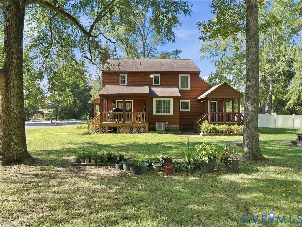 6723 Bull Hill Road, Prince George, VA 23875 Two-story residence featuring wood siding, dual covered porches, and an expansive yard with mature trees