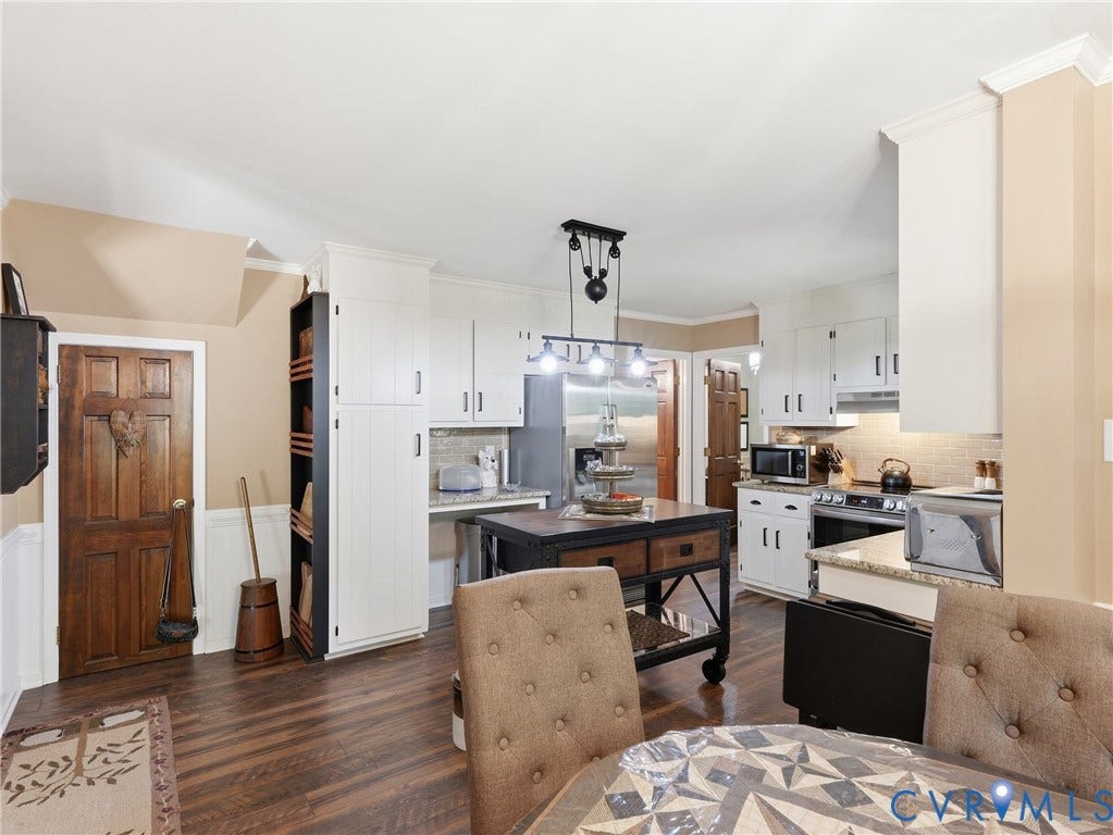 6723 Bull Hill Road, Prince George, VA 23875 Kitchen featuring white cabinetry, wood-finish flooring, stone-style countertops, stainless steel appliances, and a hanging pulley-style light fixture